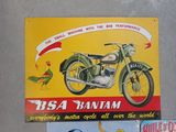 three vintage motorcycle posters on display on the wall