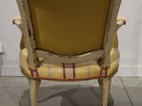 an image of a chair with a yellow seat and a red and white checkered upholstered back