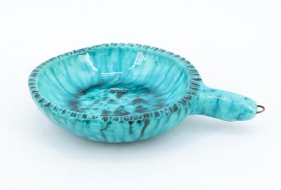 blue ceramic bowl with a turtle shaped handle on a white background
