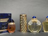 three bottles of perfume sitting next to each other on a table