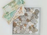 a box full of coins and money sitting on a table