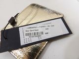 a gold card case with a price tag on top of it