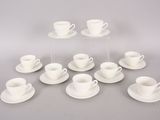 several cups and saucers are arranged in a circle on a table