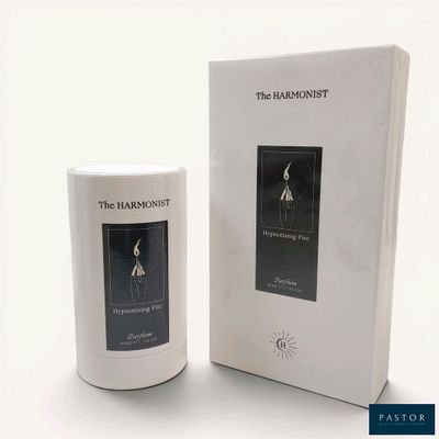the harmonyist candle in a white box next to a white box