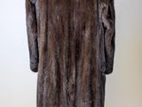 a close up of a fur coat on a mannequin stand