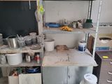 a small kitchen with lots of pots and pans on the counter