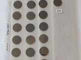 a lot of coins in a plastic bag on a table