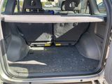 the back of a car with the door open and the back seats down