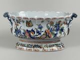 a large white bowl with blue and orange flowers on it