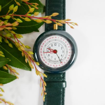 an image of a close up of a watch with flowers in the background