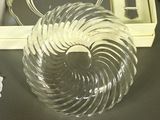 a glass sculpture of a spiral shaped object on a table