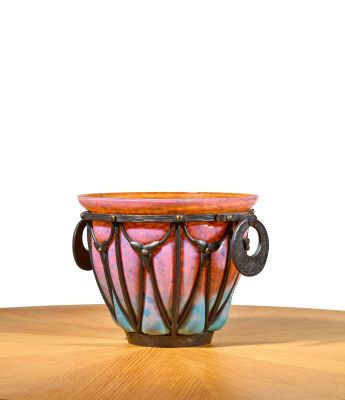a colorful vase sitting on top of a wooden table