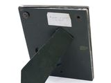 a picture of a black picture frame with a tie on it