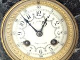 a clock that is sitting on a marble table