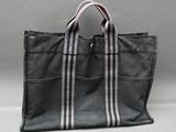 a black and white striped tote bag sitting on top of a table