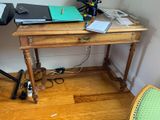 a wooden desk with a laptop on top of it
