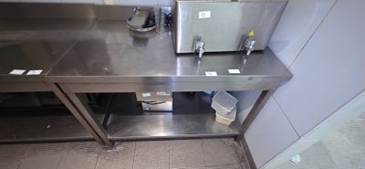 a stainless steel counter with a toaster on it