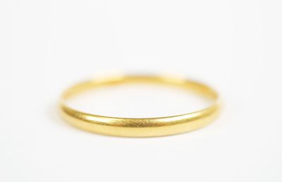 a close up of a gold ring on a white surface