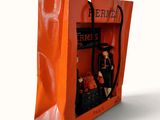 an orange bag with a picture of a man and a woman inside of it