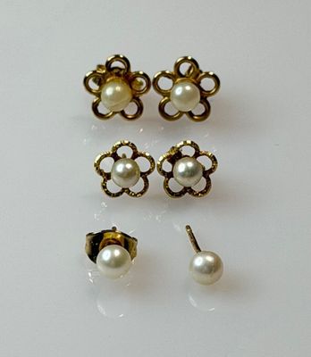 three pairs of pearl earrings and a pair of stud earrings