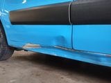 a blue car with a black stripe on the side of it