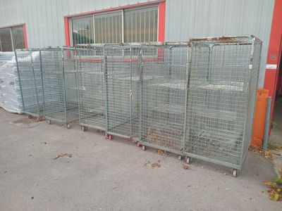 many cages lined up in front of a building
