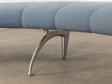 a blue bench sitting on a concrete floor in a room