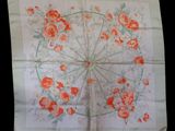 an image of a white handkerchief with orange flowers on it
