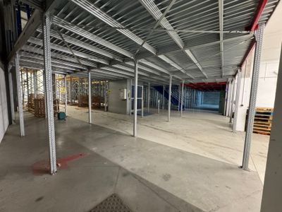 a large empty warehouse with a lot of steel beams