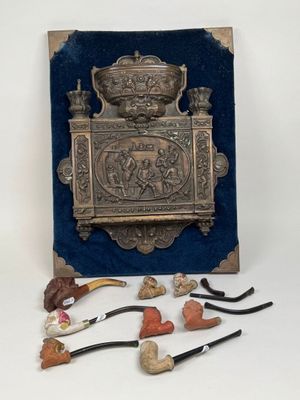 a metal box with various items in it on a white surface