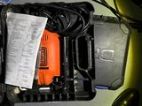 a person holding a tool in a box on the floor