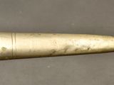 a close up of a metal object with a knife in it