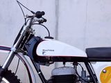 a motorcycle that is parked in front of a wall