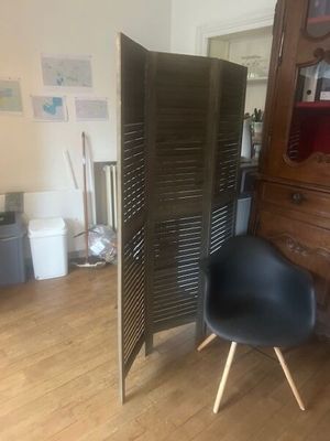 a chair that is sitting in front of a cabinet