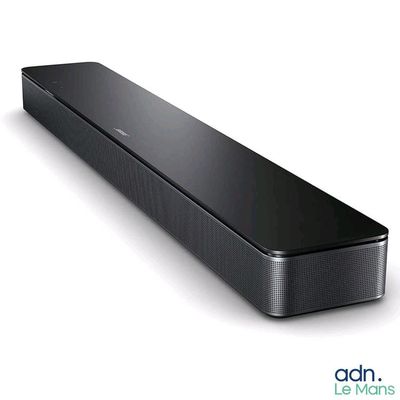 un gros plan d'une barre de son noire posée sur une surface blanche