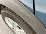 a close up of a car ' s front bumper and tire