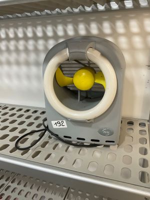 a small fan that is on a shelf in a room
