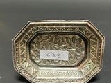 an antique silver plate with a small label on it