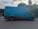 a blue van that is parked in a parking lot