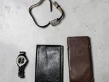 a wallet, a watch, and a wallet on a table