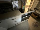 a kitchen with a sink, oven, microwave and a window