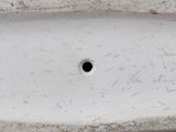 a white toilet with a hole in the middle of it