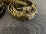 two belts that are sitting on a table