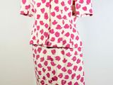 pink and white leopard print dress and jacket on a mannequin stand