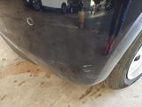a close up of a car ' s bumper with a small hole in it