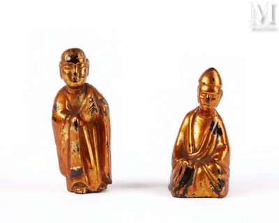 pair of gold figurines of a monk and a seated monk