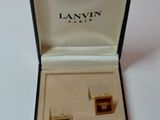an image of a pair of cufflinks in a box on a white surface