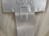 a white dress with a gold trim and a label on it