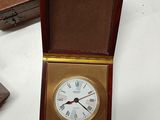 a small wooden box with a clock inside of it