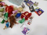 a lot of little mermaid dolls on the table